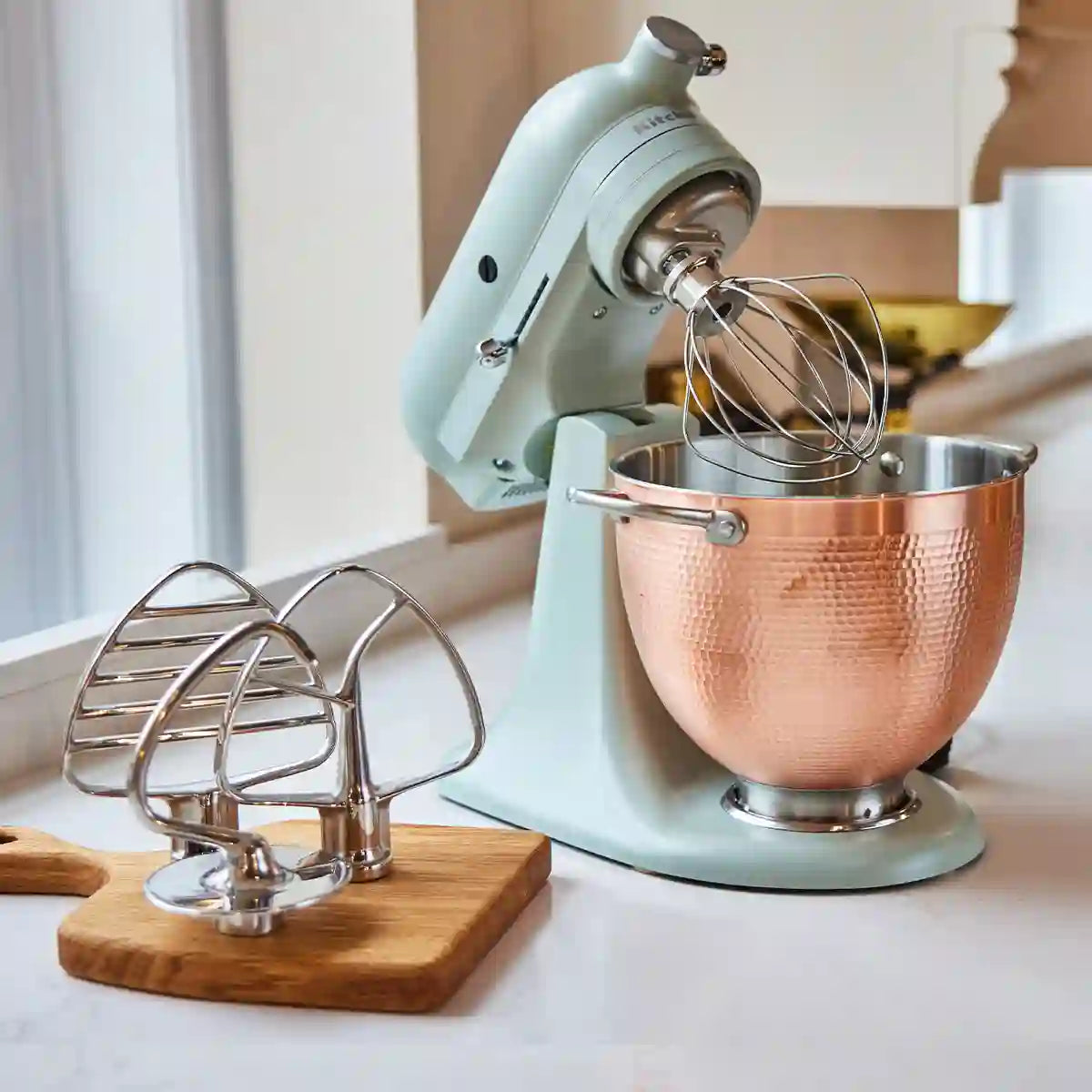 KitchenAid Blossom Artisan stand mixer lifestyle image with whisk attachment